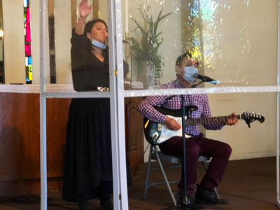 Woman singing while man plays guitar